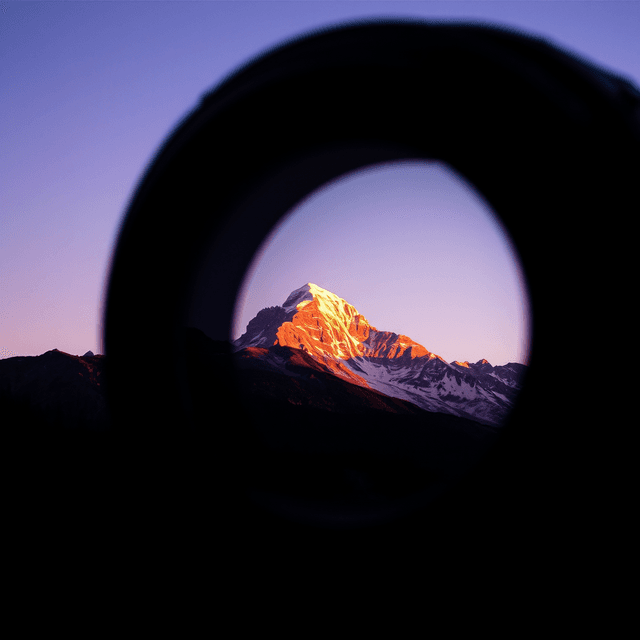 camera lens, golden hour light, mountain peak, digital decay, scan lines